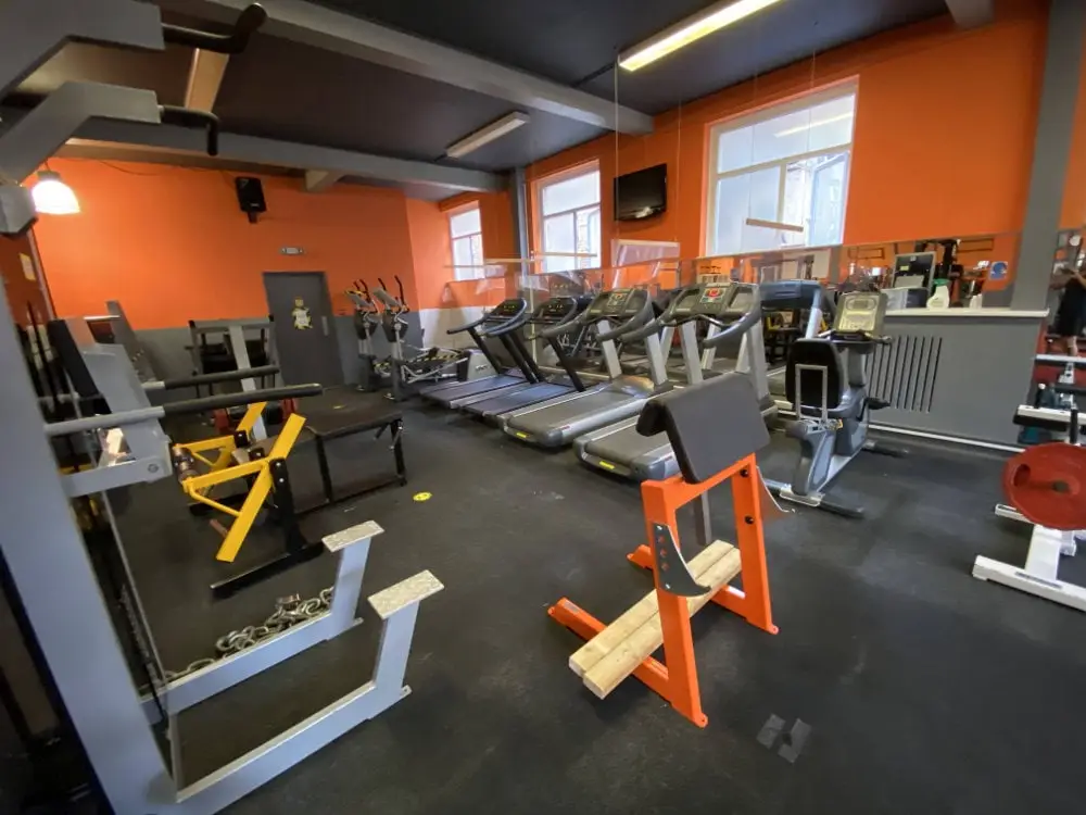 Treadmills and plate-loaded machines on the gym floor, The Bar Gym Worthing